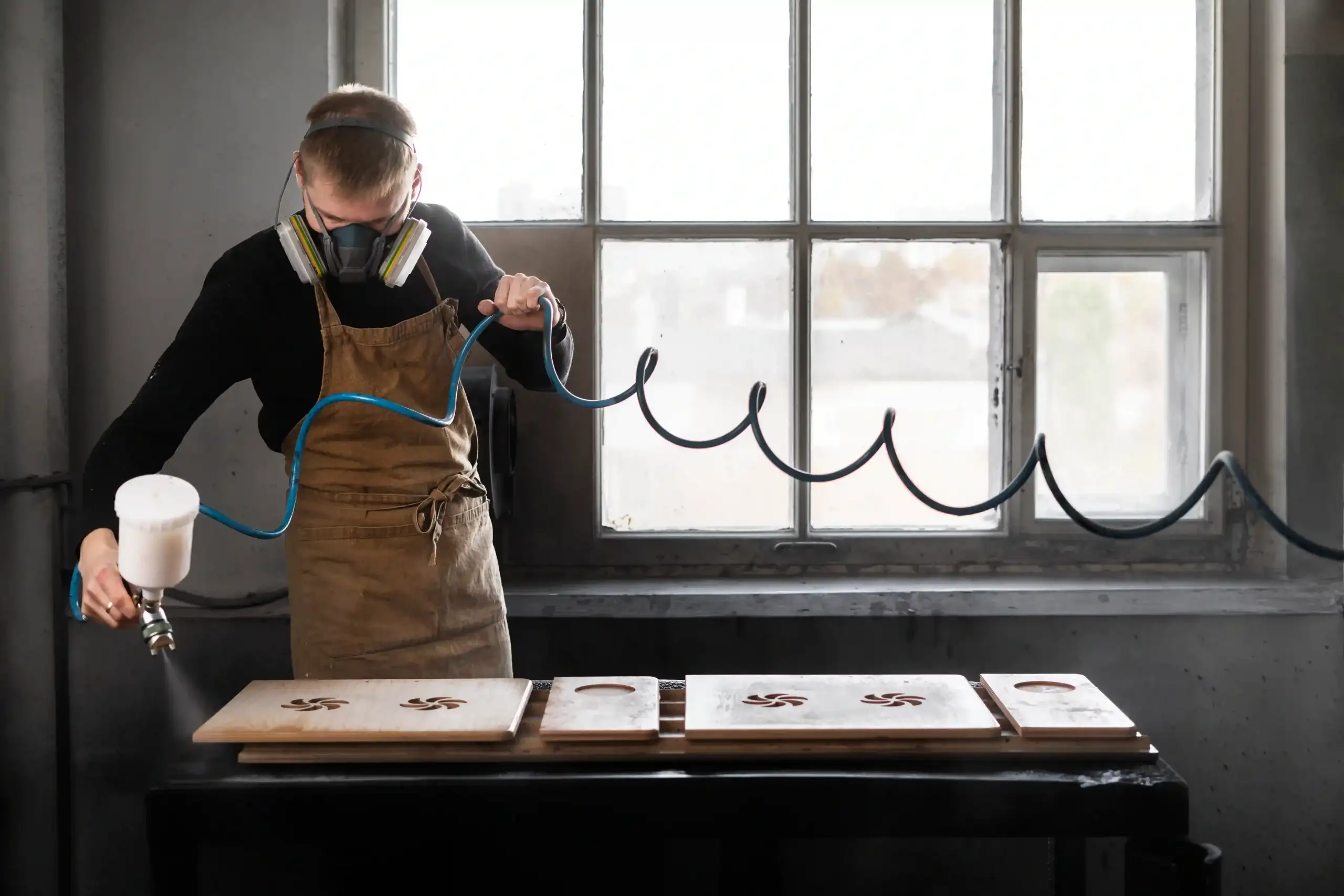 young male working wood engraving workshop scaled 1